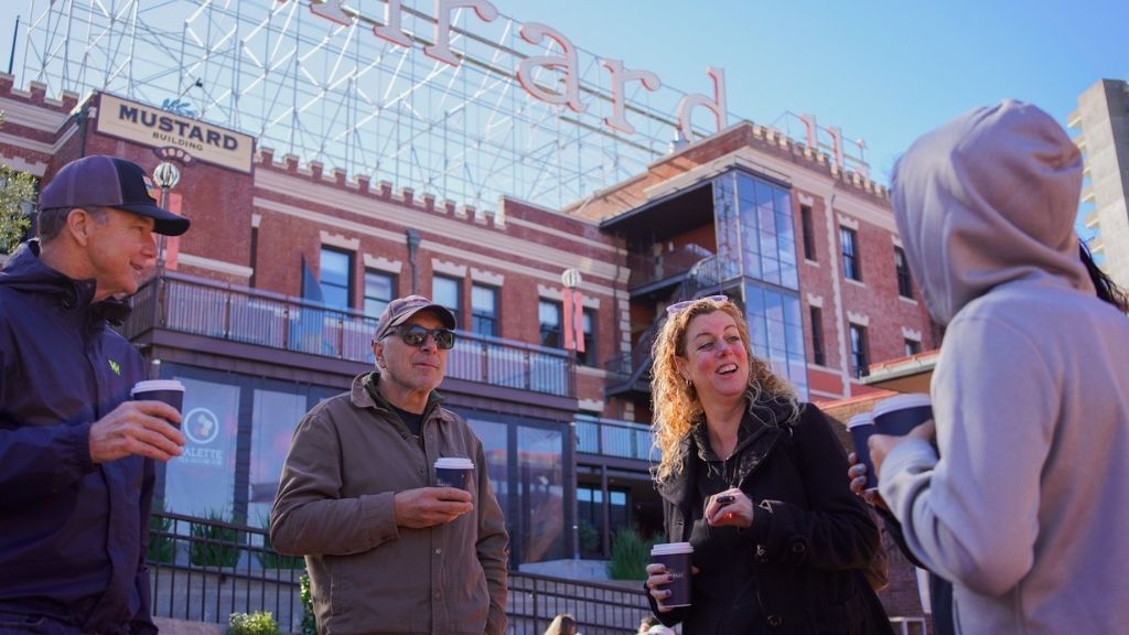 A group of people tasting sweet Ghiradelli hot chocolate on a Food Tour on Fisherman's wharf.
