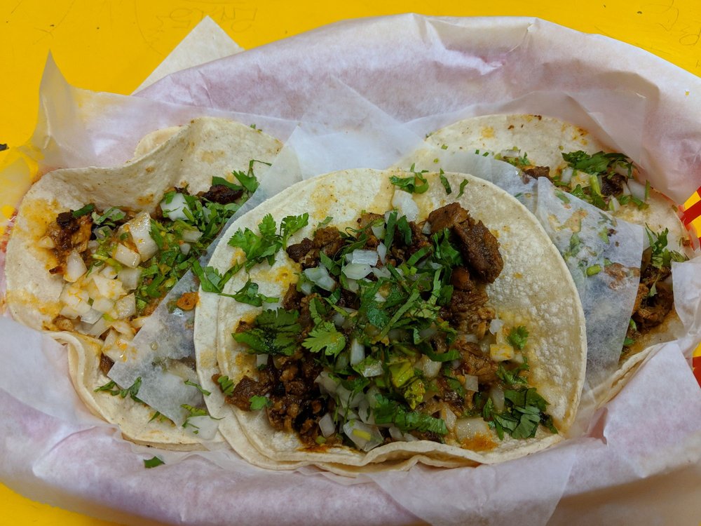 Close-up of al pastor tacos at Taqueria El Farolito, a popular San Francisco restaurant known for its no-frills Mexican food and vibrant flavors.