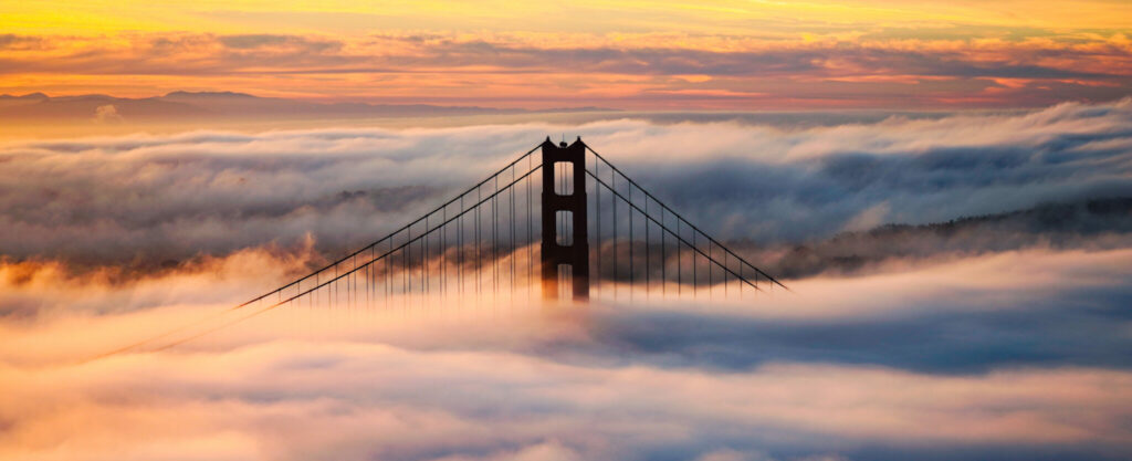 Golden Gate Bridge tower emerging from morning fog—scenic vista on a private food tour in San Francisco