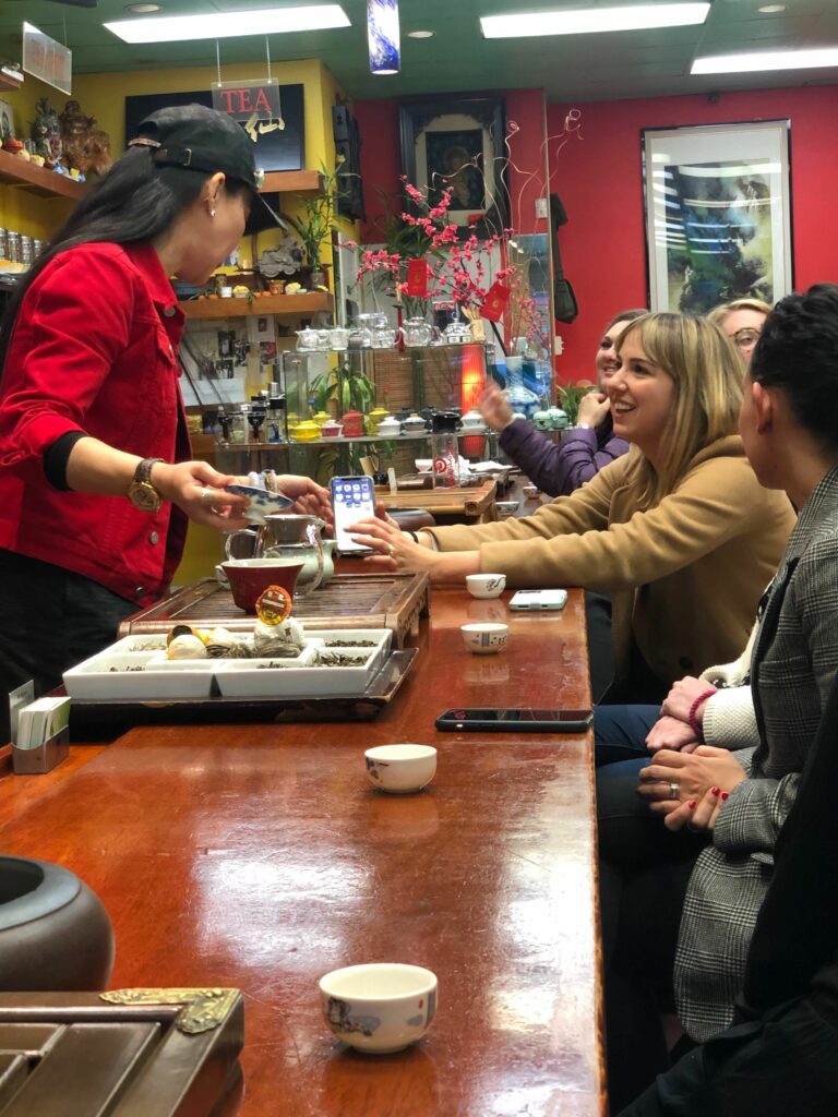 People tasting tea at a tradition Chinatown tea shop on a Chinatown Food Tour in San Francisco.
